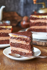 Chocolate cake on a wooden table. Side view