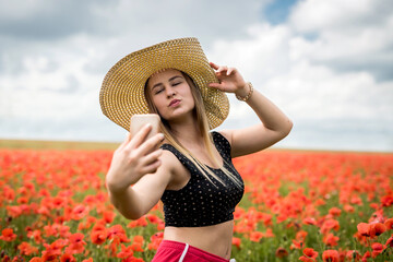 Ukrainian pretty girl enjoying flowers in countryside