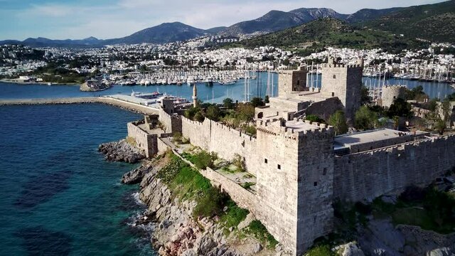 Amazing panoramic view from drone of beautiful full of yachts Bodrum harbour and ancient Kalesi castle in Mugla province in Turkey
