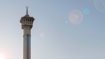 Mosque minaret at sunset against blue sky - 428734160