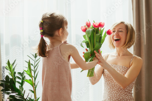 Little girl congratulating her mother wih Mother's Day