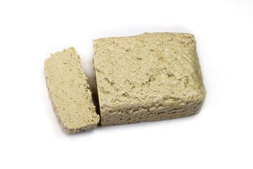 Sunflower halva close-up. Halva briquette isolated on white background. Sweet oriental dessert halva. Sweets for tea.