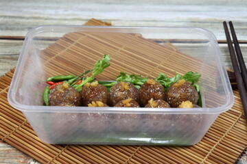 Pile of Sago pork (Tapioca balls with pork filling) serving in the plastic box. Famous ancient snack or supper in Thailand. 