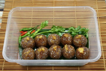 Pile of Sago pork (Tapioca balls with pork filling) serving in the plastic box. Famous ancient snack or supper in Thailand. 