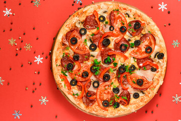 Christmas Pizza on a red background. Isolated. Flat lay, top view.