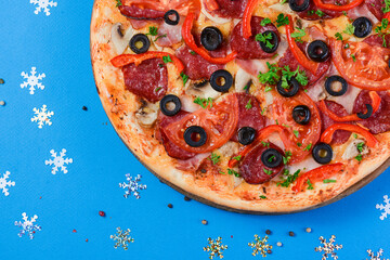 Christmas Pizza on a blue background. Isolated. Flat lay, top view.