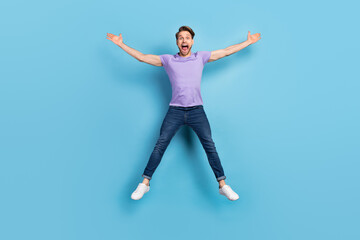 Fototapeta na wymiar Full length body photo of young man jumping up screaming loudly isolated on pastel blue color background