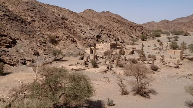 An aerial view of the abandoned traditional Arab family house in Wadi Massal, Saudi Arabia. The drone flying out.