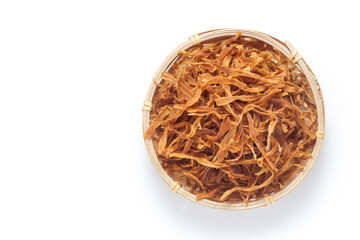 Shredded dried bamboo shoots in a basket isolated on white background. Top view.