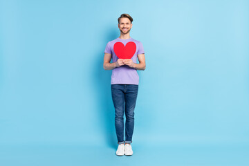 Fototapeta na wymiar Full length body profile photo of confident guy embracing red heart on date isolated on pastel blue color background