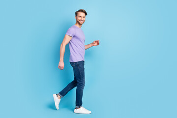 Fototapeta na wymiar Full length body size side profile photo of confident guy going forward on meeting isolated on pastel blue color background