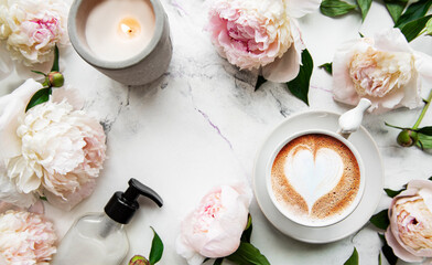 Pink peony flowers and cup of coffee