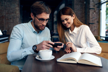 business man and woman sitting at the table communication work colleagues technology