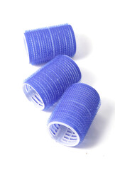 Blue plastic hair curlers isolated on a white background. Hair rollers of large diameter.