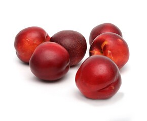 group of whole ripe red nectarines peaches isolated on a white background. Beautiful ripe fruit. Vegetarian food.