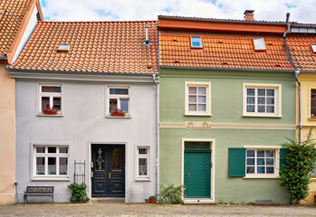Leaning roofs on a renovated semi detached house with historic windows and doors in the old town of Wismar.