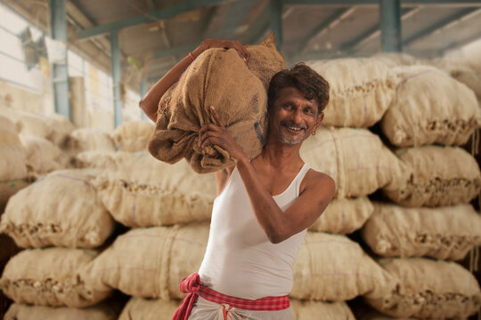 A FARMER CARRYING HIS PRODUCE 	