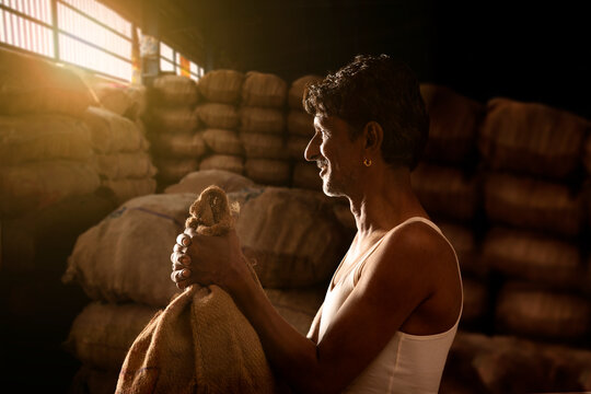 A FARMER WITH HIS PRODUCE AT A MANDI OR WHOLESALE MARKET	