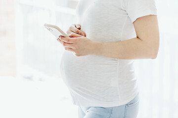 Pregnant woman holding mobile phone