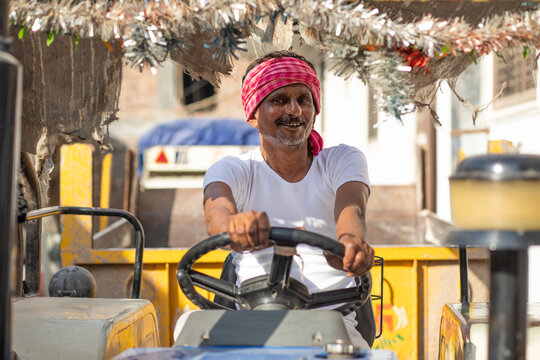 Indian Farmer Driving A Tractor	