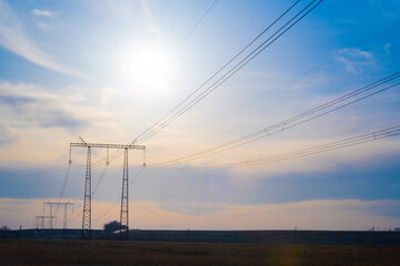 Electric high voltage pole at sunset background