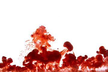 Red paint dissolving in water creating abstract shapes