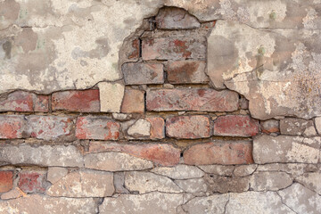 Old cracked brick wall with cement surface