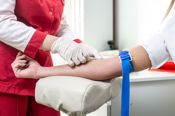The process of taking blood from the vein from the hand.