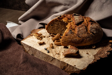 Bread and drying lie on a wooden board on a dark background