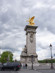  View of the Pont Alexandre lll. On the bridge are pedestrians and cars