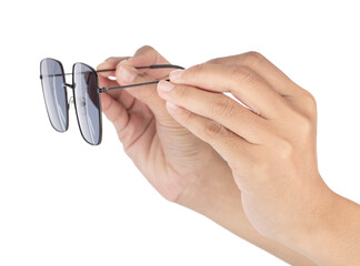 Hand holding Black sunglasses isolated on white background
