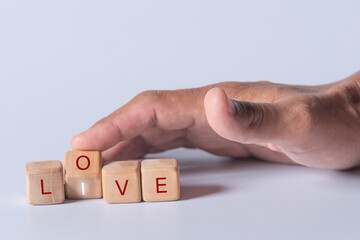Hand holding dice with text for illustration of "Love and Live" words
