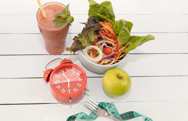Top view of Intermittent fasting and Healthy food with salad food in the morning on wooden background