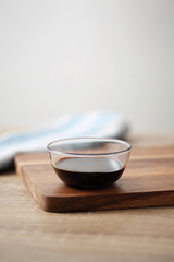 Chinese soy sauce in small cup on table