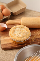 Woman hold meat pie on wooden tray