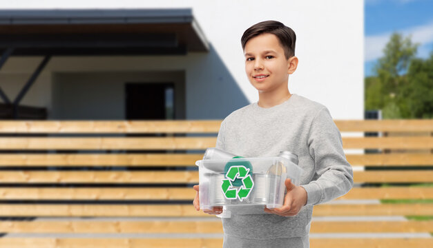 metal recycling, waste sorting and sustainability concept - smiling boy in striped t-shirt holding plastic box with tin cans over house background - Powered by Adobe