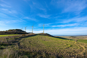 Fototapeta na wymiar Windmills between earth and sky