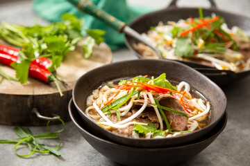 Vietnamese beef pho in black bowls 