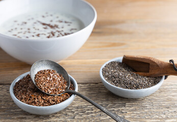 Healthy super foods flax seeds in a bowl mixed with yoghurt ready to eat. These seed are very healthy and can be eaten with a variety of different dishes.