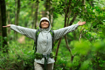 Freedom woman backpacker  hiking open arms in spring forest