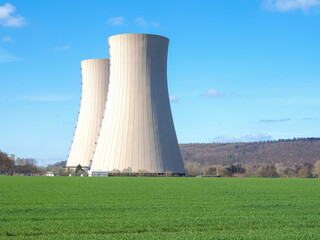 nuclear power plant against sky and green grass