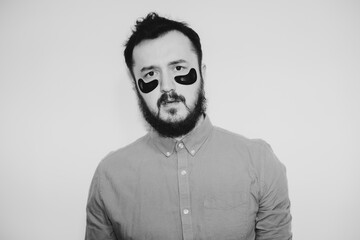 Handsome bearded hipster man with eye patch on the face. Stylish black and white photography