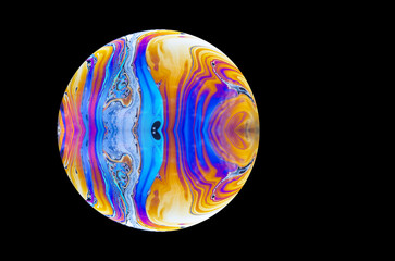 close up of a soap bubble. Close up of a abstract, soap bubble resembling a planet. Copy space on a...