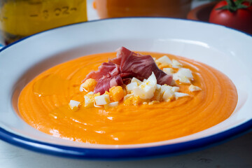 Salmorejo, typical cold tomato soup with iberico ham and boiled eeg and olive oil.