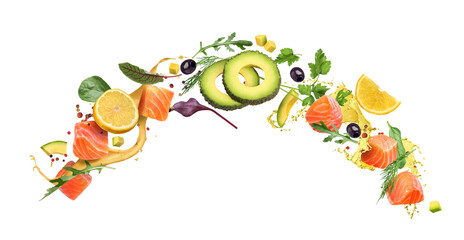 Pieces of red fish with avocado and vegetables on a white plate