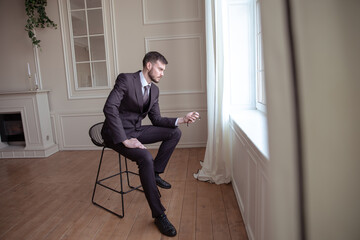 handsome businessman showing time on his watch