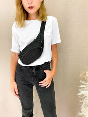 Beautiful young woman in blank white t-shirt and black jeans