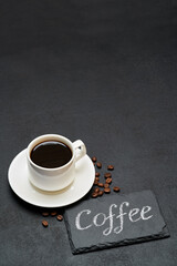 Coffee handwritten inscription sign on chalk board and cup of espresso coffee