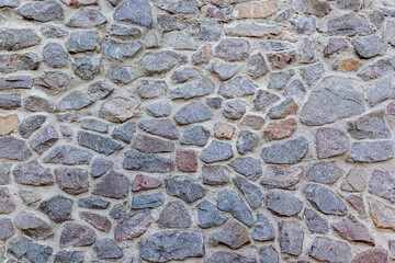 Old castle wall made of granite stone