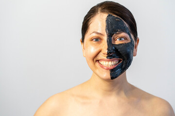 Woman relaxing with black charcoal facial mask